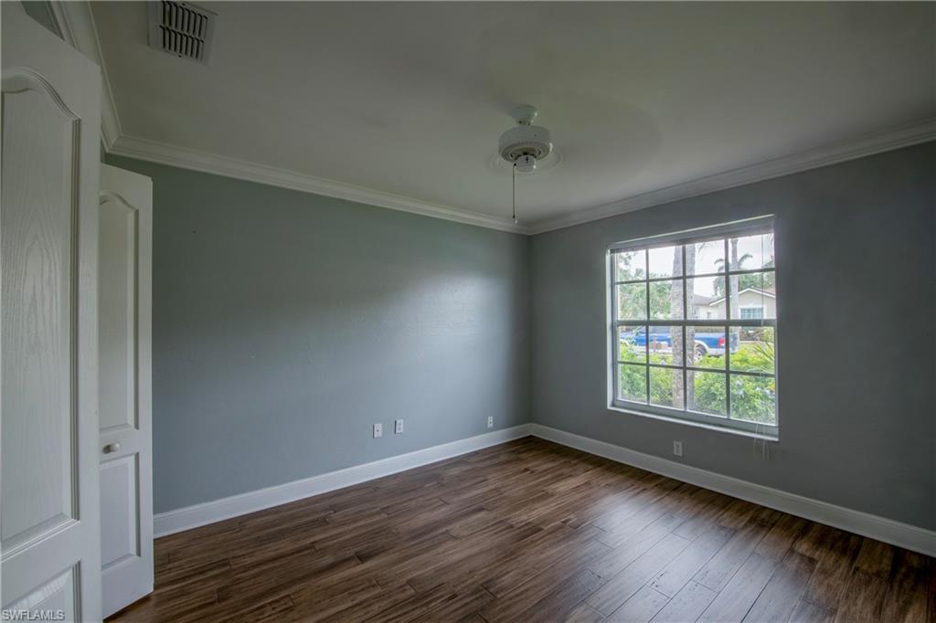 9229 Lanthorn Way Estero, FL 33928 - Photo 14 of 41 an empty room with wooden floor and windows