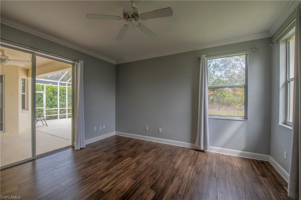 9229 Lanthorn Way Estero, FL 33928 - Photo 17 of 41 an empty room with wooden floor fan and windows