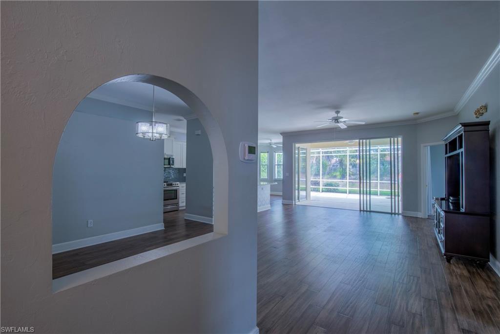 9229 Lanthorn Way Estero, FL 33928 - Photo 3 of 41 wooden floor in an empty room with a window