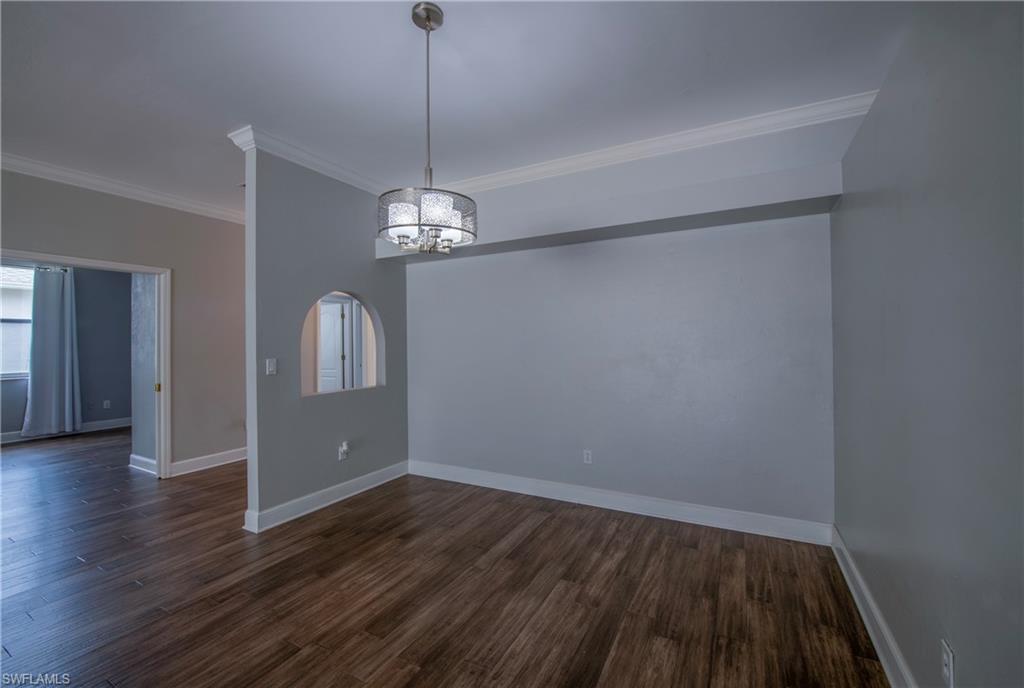9229 Lanthorn Way Estero, FL 33928 - Photo 6 of 41 a view of empty room with wooden floor