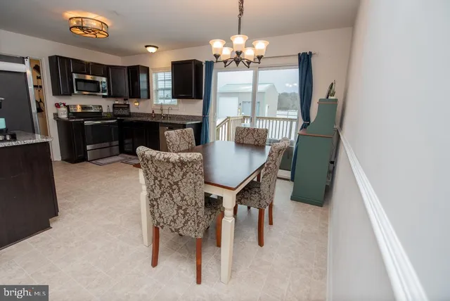 a view of a dining room with furniture and a chandelier