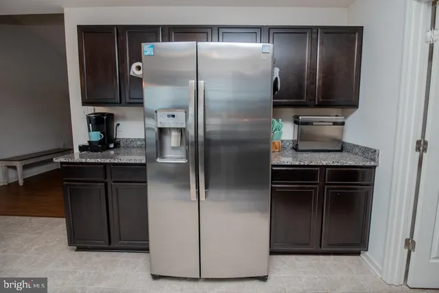 a kitchen with a refrigerator and a sink