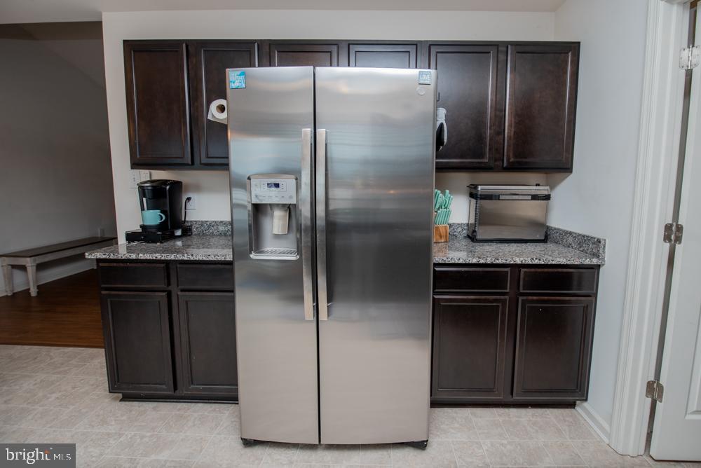 17180 Philips Hill Road Laurel, DE 19956 - Photo 16 of 65 a kitchen with a refrigerator and a sink