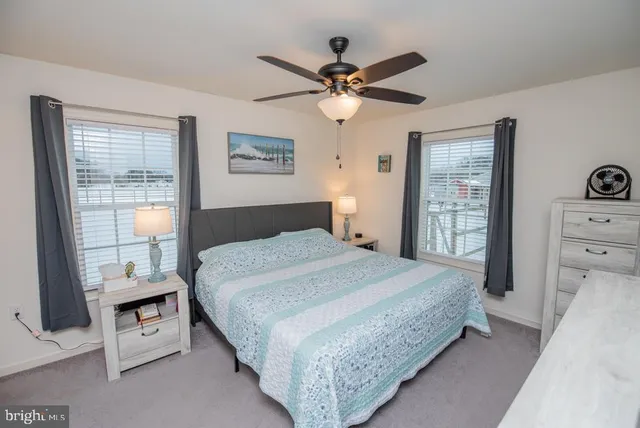 a bedroom with a bed a flat screen tv and a dresser