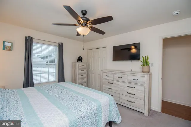 a bathroom with a granite countertop sink toilet and mirror