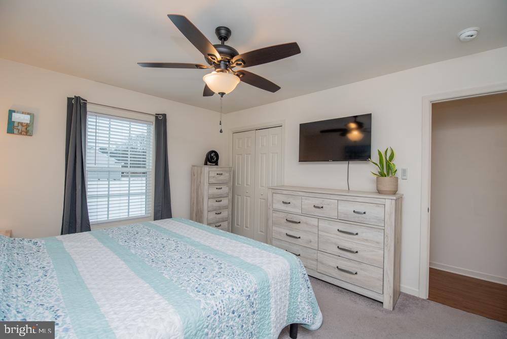 17180 Philips Hill Road Laurel, DE 19956 - Photo 23 of 65 a bedroom with a bed a flat screen tv and a dresser