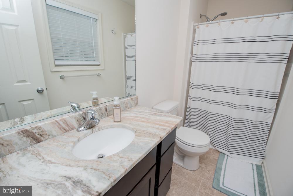 17180 Philips Hill Road Laurel, DE 19956 - Photo 25 of 65 a bathroom with a granite countertop sink toilet and mirror