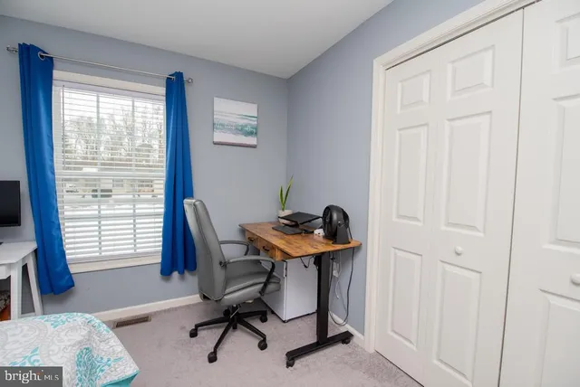 a spacious bedroom with a bed and a dresser