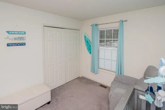 a white bath tub sitting next to a white shower