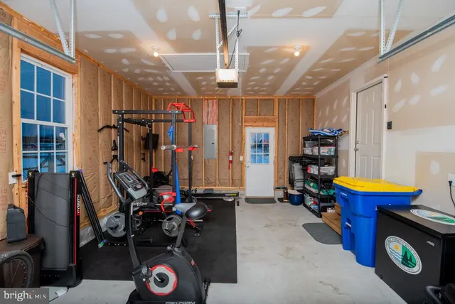 a front view of a house with a yard and large trees