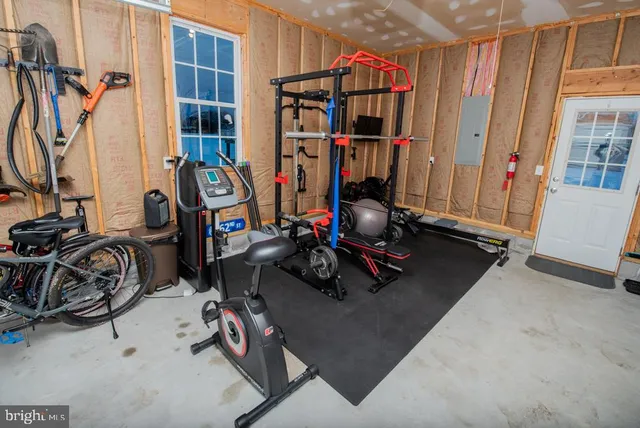 a front view of a house with a yard and large trees