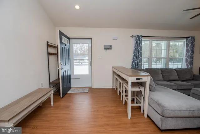 a living room with furniture and a wooden floor