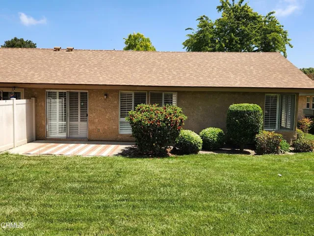 a house with green field in front of it