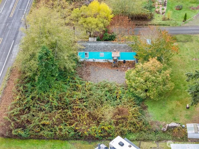a vase with flowers on it with wooden floor