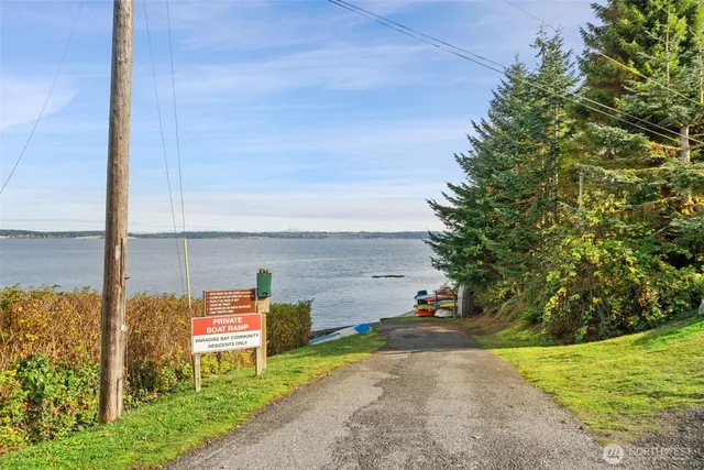 a view of car parked on the side of road with ocean view