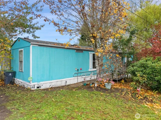 a backyard of a house with table and chairs
