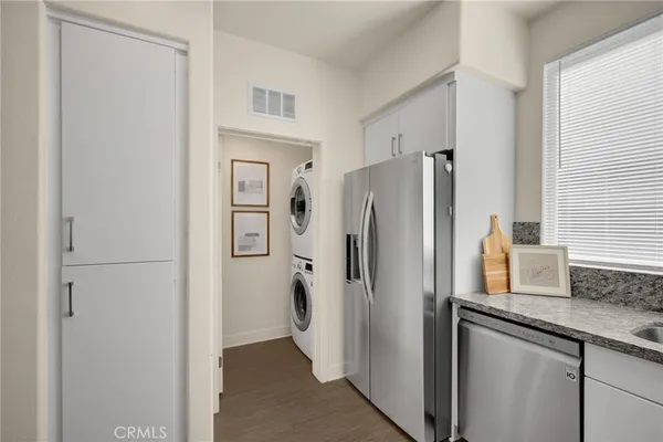 a kitchen with stainless steel appliances a refrigerator and a sink