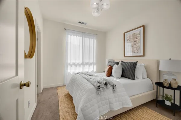 a large bedroom with bed and window
