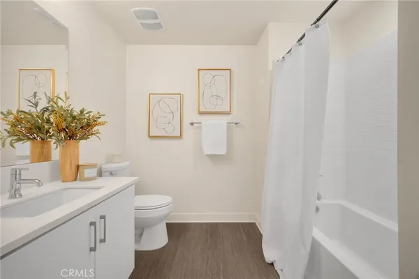 a bathroom with a sink mirror and toilet