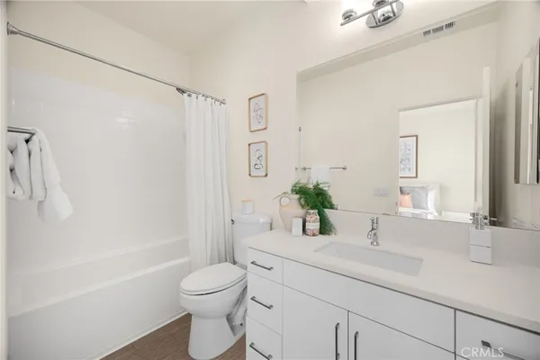 a bathroom with a granite countertop sink a mirror and a shower