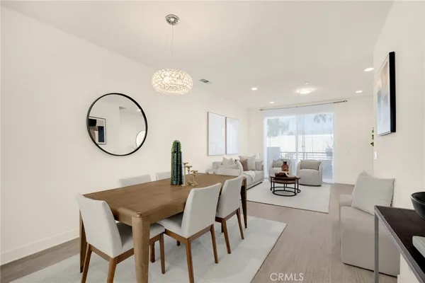 a view of a dining room with furniture and a mirror