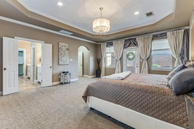 a spacious bedroom with a large bed and a large window