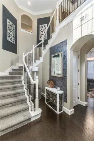 a view of staircase with black white walls