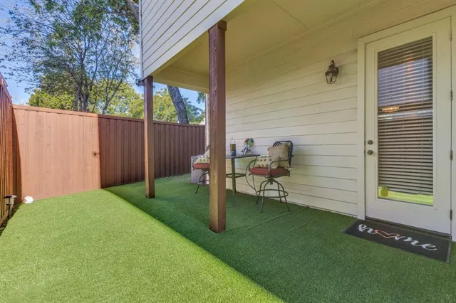 a backyard of a house with table and chairs