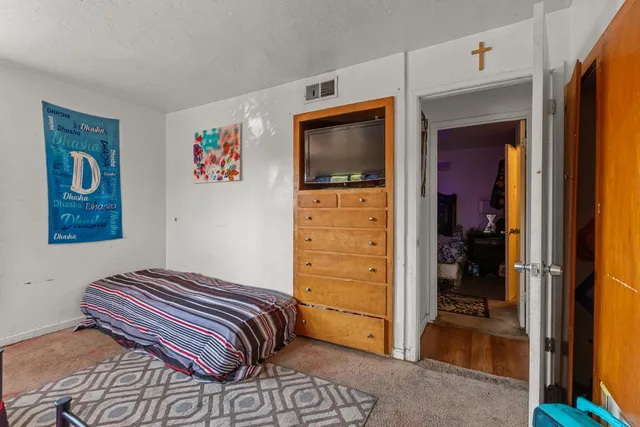 a bedroom with a bed and a mirror