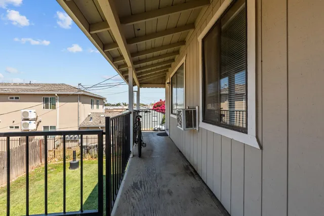 a view of a porch with wooden floor and outer view