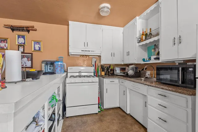 a kitchen with a sink and cabinets