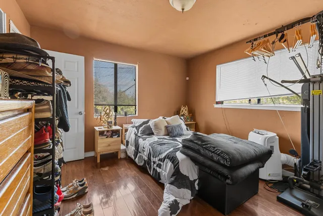 a bedroom with furniture and a closet