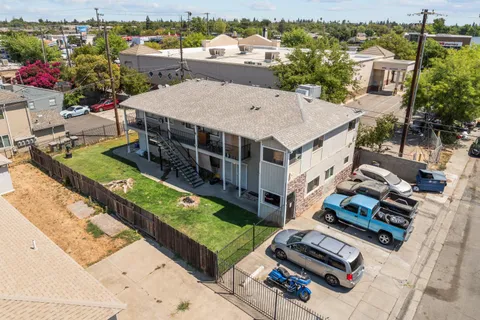 an aerial view of a house with a garden and lake view