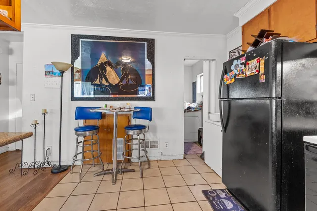 a view of a refrigerator in kitchen and a window