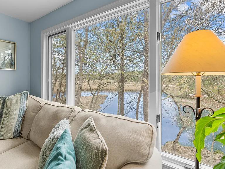 15 Riverview Avenue, Unit D Mashpee, MA 02649 - Photo 5 of 33 a bed sitting in a bedroom next to a window