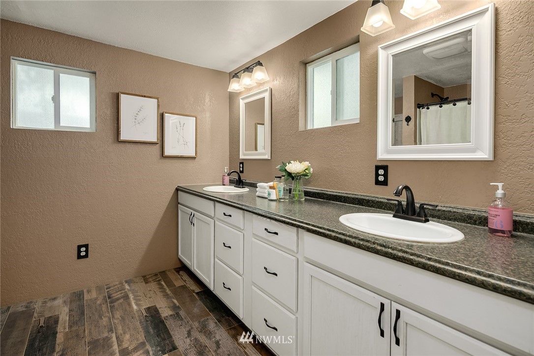 2613 Northeast 7th Street Renton, WA 98056 - Photo 13 of 23 a bathroom with a granite countertop sink a mirror and a