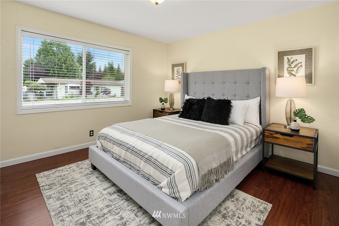 2613 Northeast 7th Street Renton, WA 98056 - Photo 14 of 23 a bedroom with a bed and wooden floor