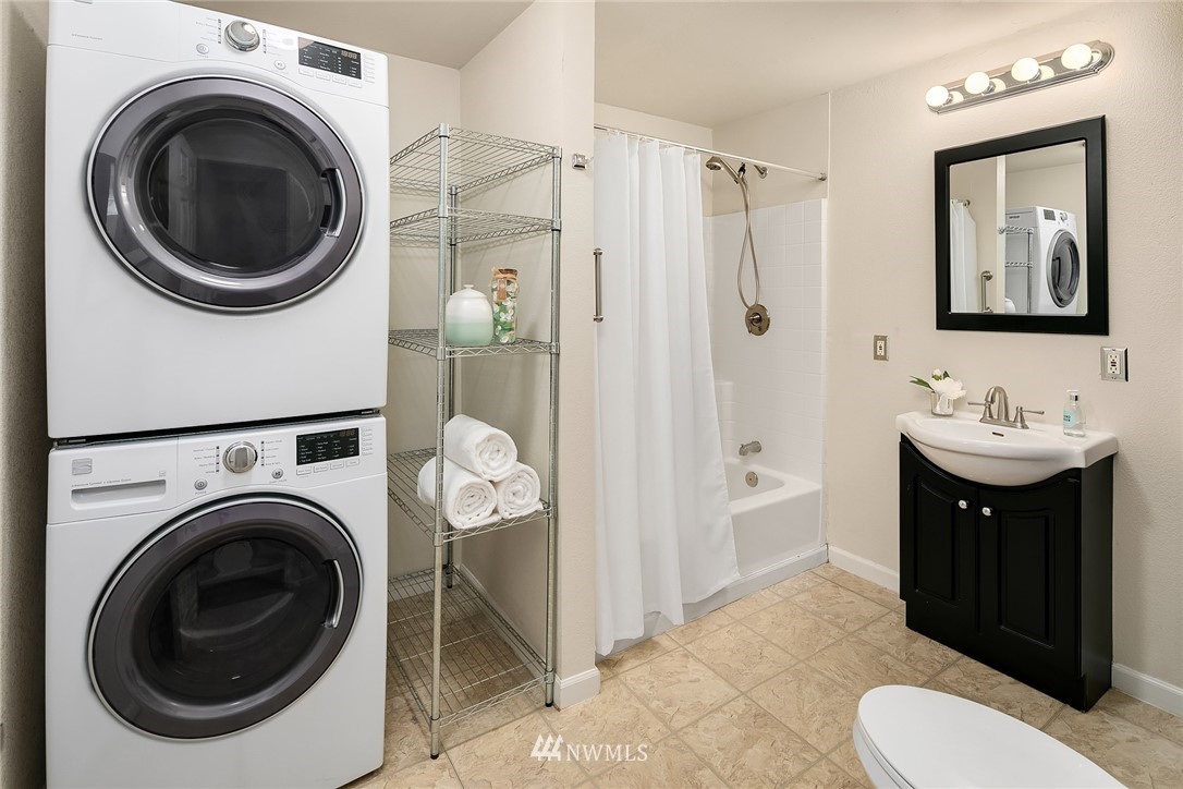 2613 Northeast 7th Street Renton, WA 98056 - Photo 18 of 23 a bathroom with a sink a mirror and toilet