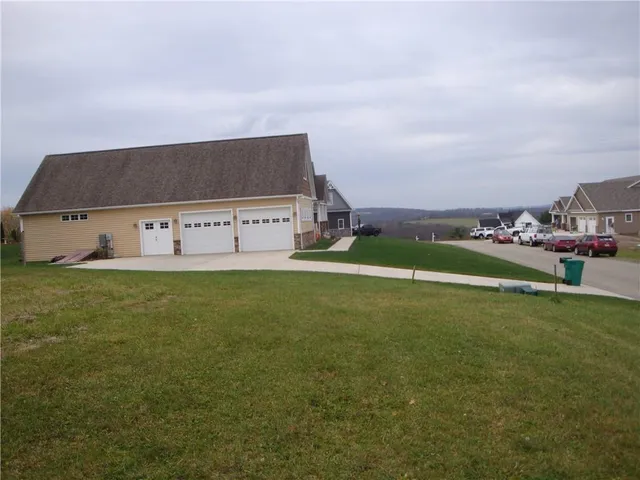 an aerial view of multiple houses with a yard