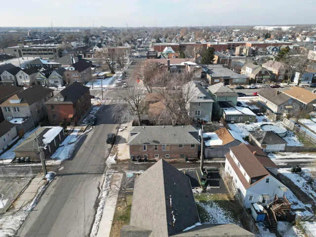 an aerial view of a house with a yard