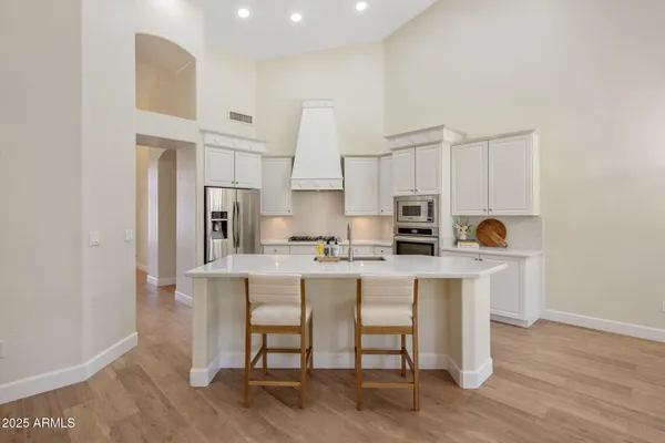 a kitchen with stainless steel appliances a refrigerator and a stove top oven