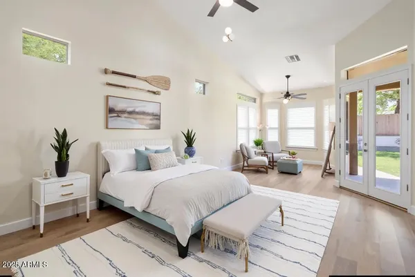 a bedroom with a bed and a potted plant