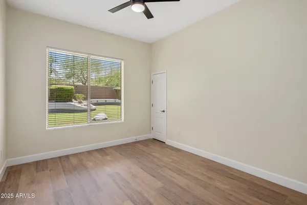 wooden floor in an empty room with a window