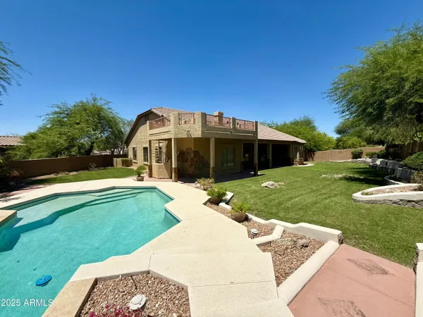 a view of a house with a backyard porch and sitting area