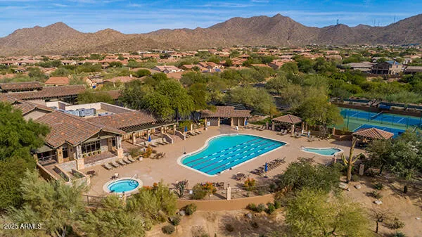 an aerial view of a house with a yard basket ball court and outdoor seating