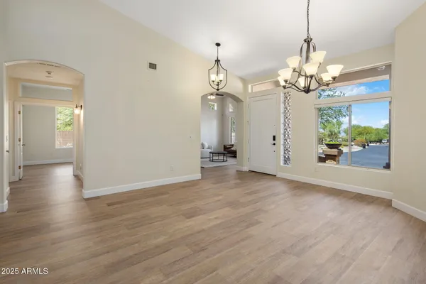 a view of a dining room with furniture wooden floor and chandelier