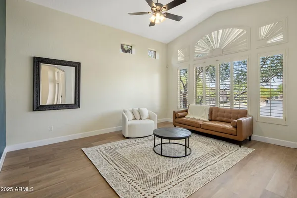 a view of a livingroom with a chandelier wooden floor and a chandelier