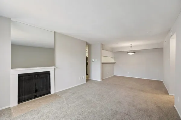 a view of empty room with a fireplace