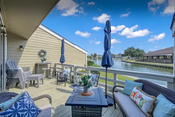 a view of a patio with couches table and chairs and potted plants