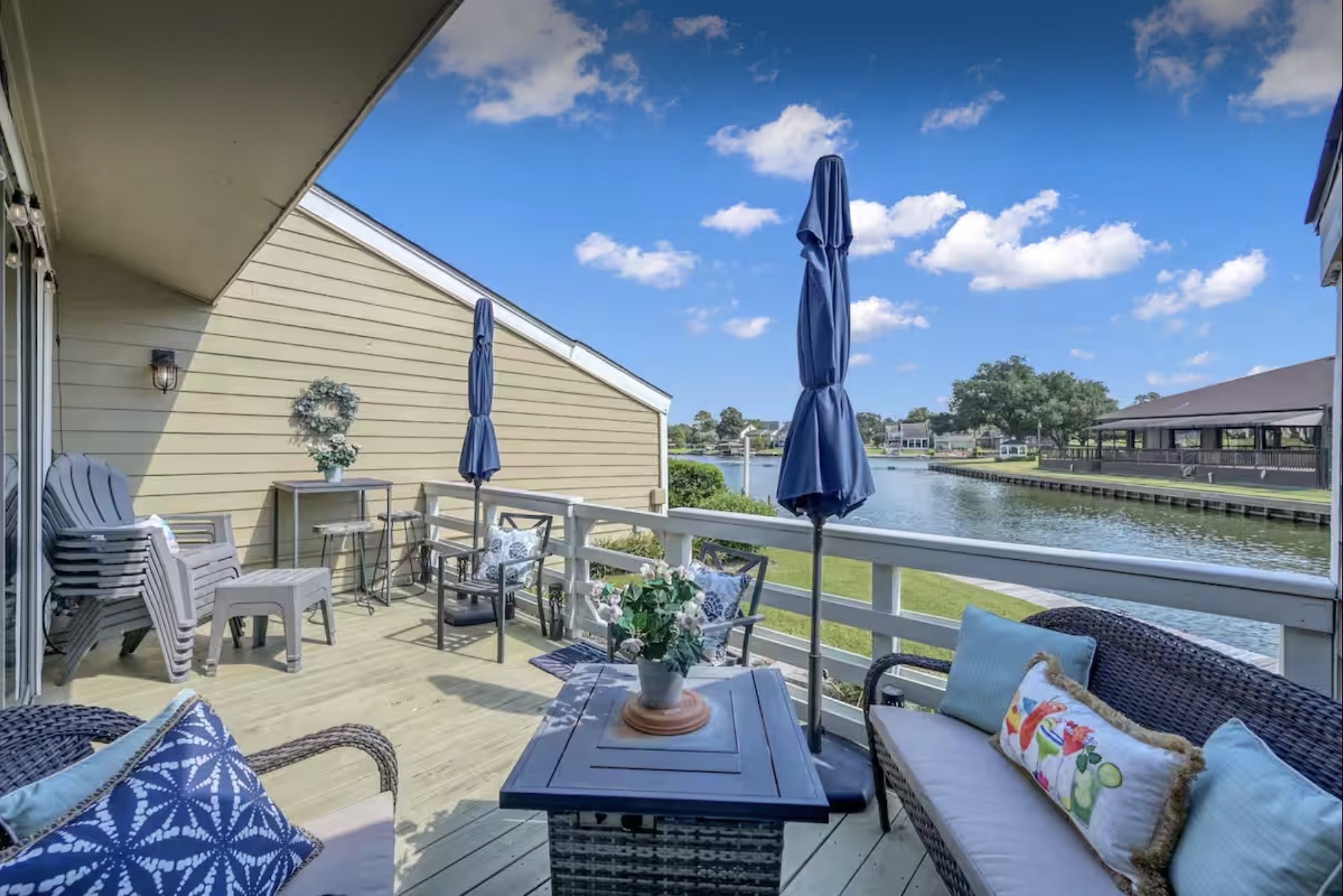 a view of a patio with couches table and chairs and potted plants